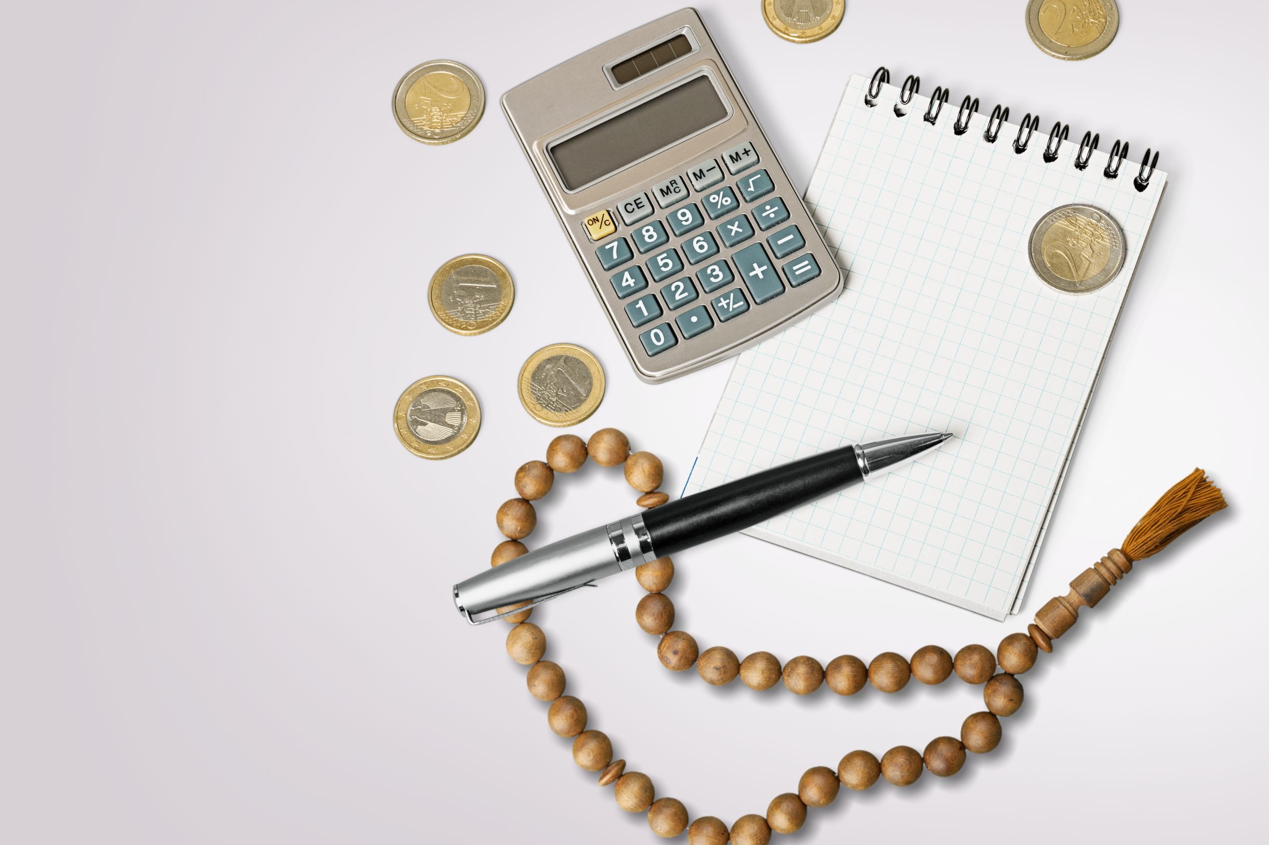 Concept of islamic finance. Coins and praying beads. Zakat, islamic banking
